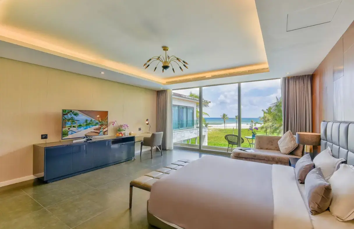 Spacious master suite in Da Nang luxury villa featuring king-size bed, private balcony, and elegant interior design