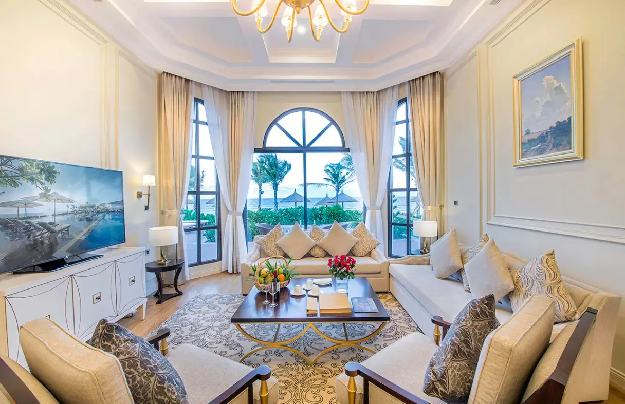 Bright, modern living room in a Da Nang villa with comfortable seating and stunning panoramic ocean views.